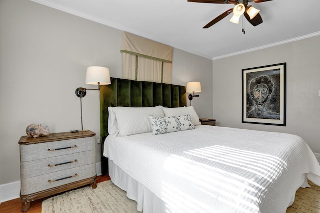 bedroom with ceiling fan, crown molding, and light wood-type flooring