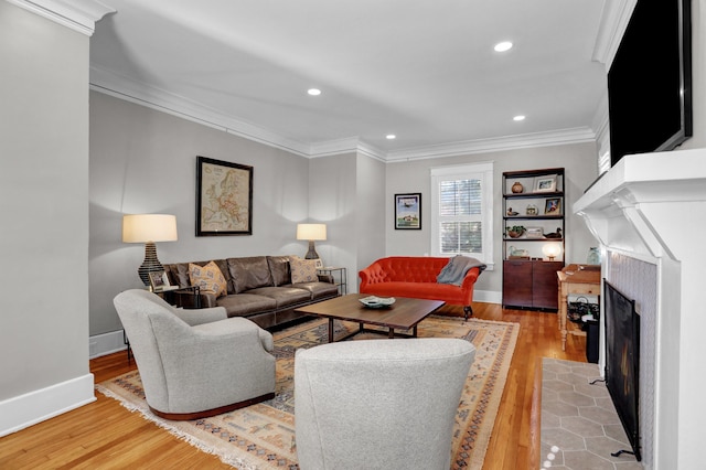 living room featuring light hardwood / wood-style floors and ornamental molding