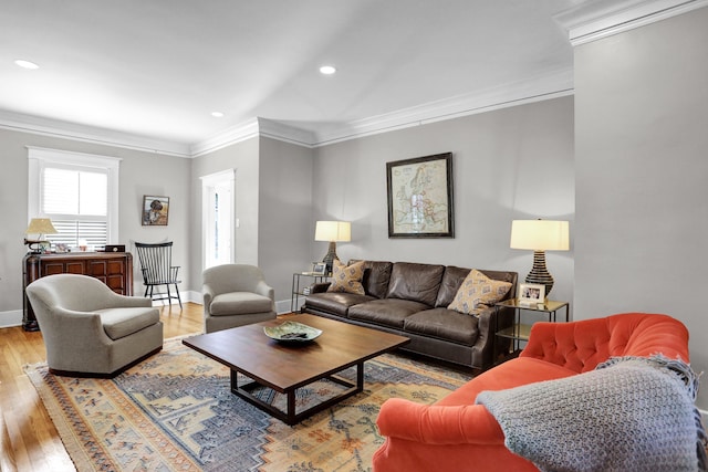 living room with ornamental molding and light hardwood / wood-style flooring