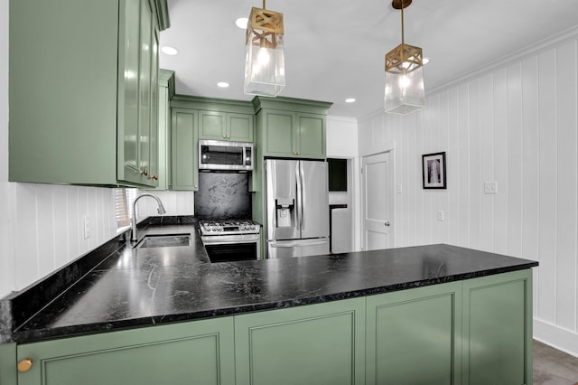 kitchen with appliances with stainless steel finishes, decorative light fixtures, green cabinetry, and sink