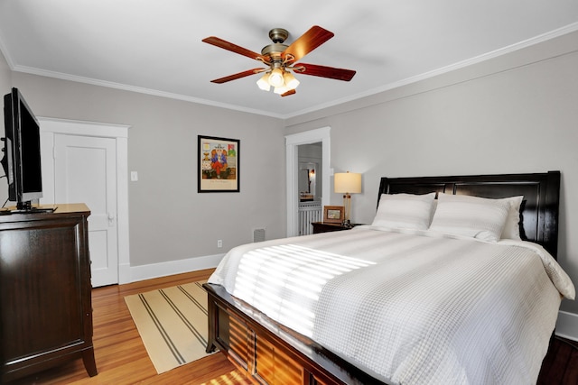 bedroom featuring ceiling fan, light hardwood / wood-style floors, and ornamental molding