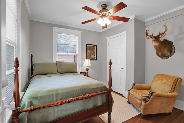 bedroom with ceiling fan, hardwood / wood-style floors, and ornamental molding