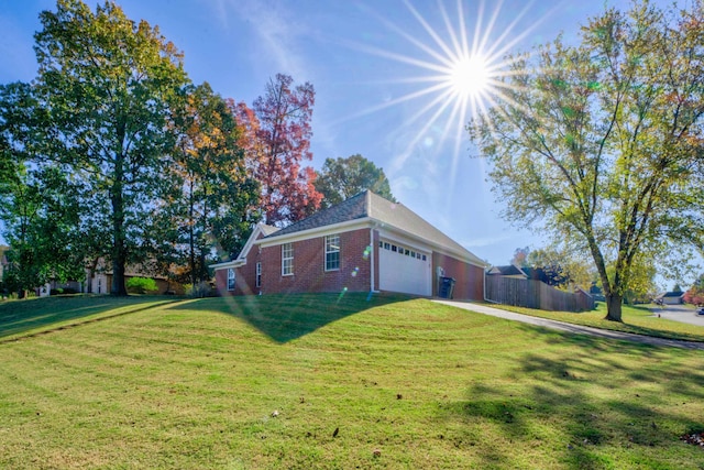 view of side of property with a yard and a garage