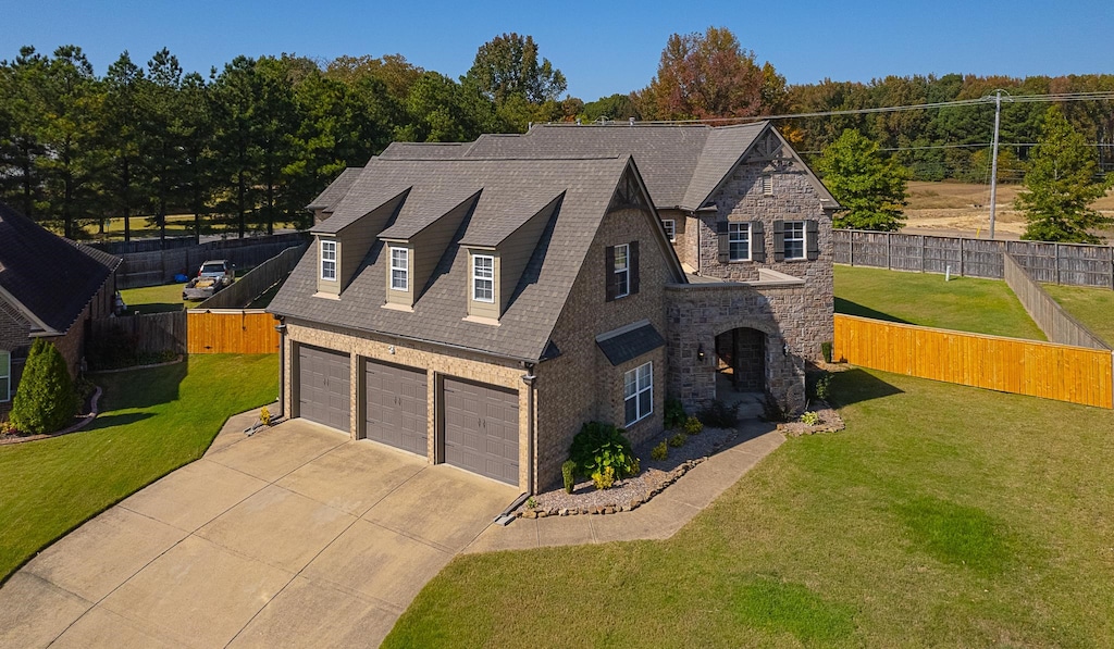 view of front facade with a front lawn and a garage