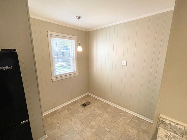 interior space featuring wooden walls and ornamental molding