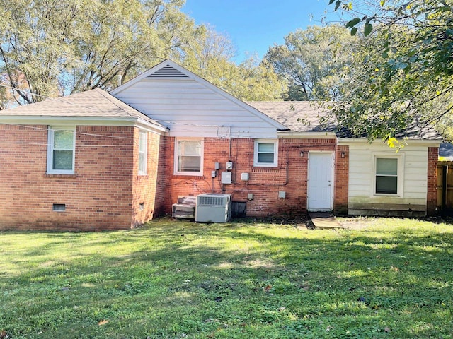 rear view of property with a yard and central AC unit