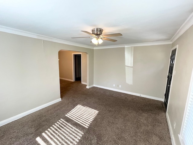 carpeted spare room with ceiling fan and ornamental molding