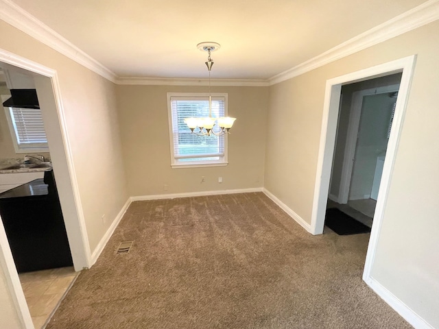 unfurnished dining area with carpet floors, an inviting chandelier, ornamental molding, and sink