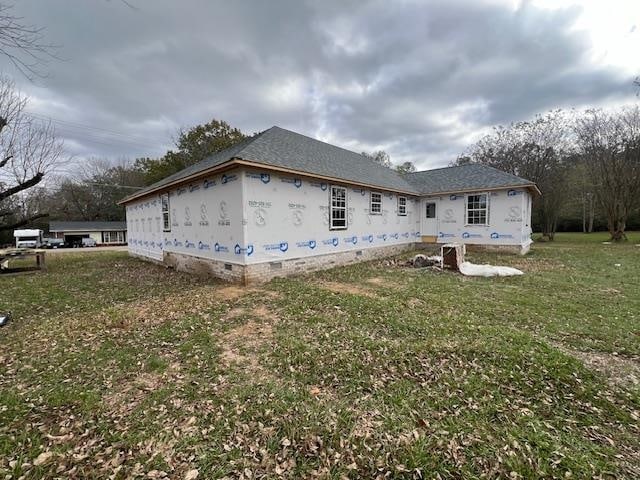 view of side of property with a yard