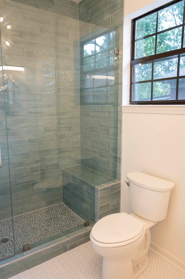 bathroom with toilet and tiled shower