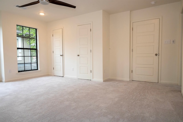 unfurnished bedroom with light carpet and ceiling fan