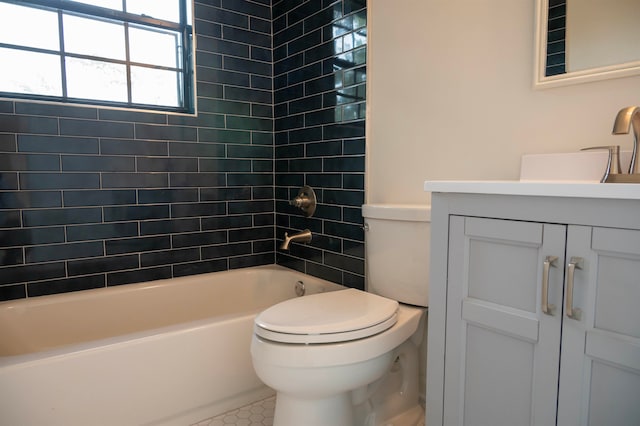 full bathroom with tile patterned flooring, vanity, toilet, and tiled shower / bath