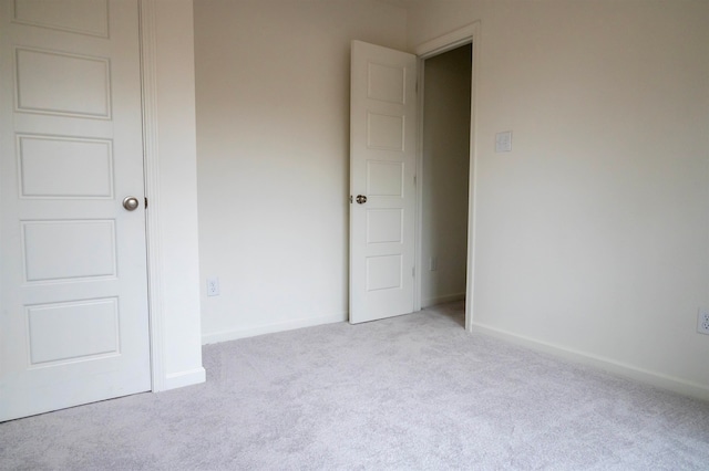 unfurnished bedroom with light carpet