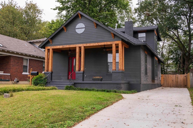 view of front of house featuring a front lawn and covered porch