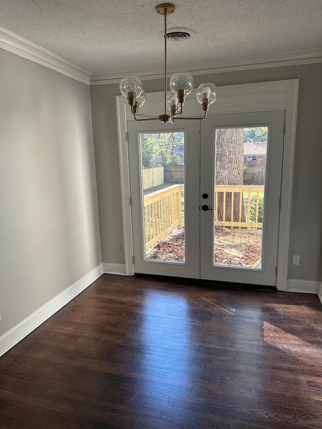 unfurnished dining area with dark hardwood / wood-style flooring, plenty of natural light, and a textured ceiling