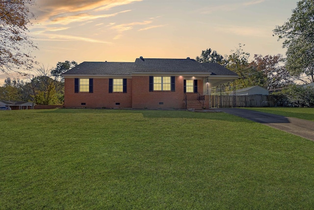 ranch-style home with a lawn