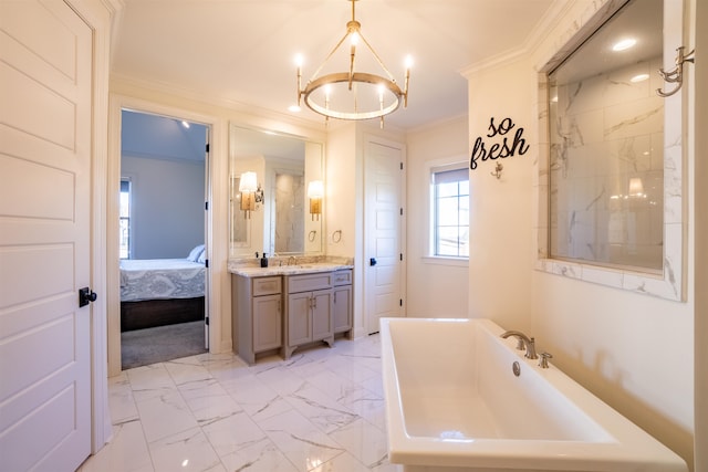 bathroom featuring a bathing tub, crown molding, vanity, and a chandelier