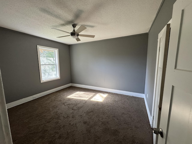 carpeted empty room featuring ceiling fan and a textured ceiling