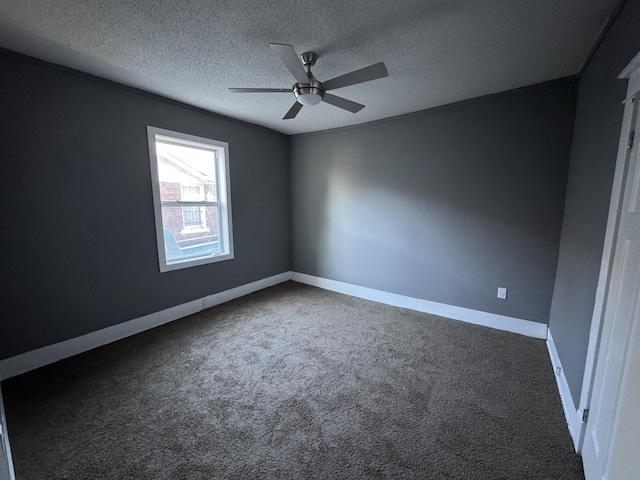 carpeted spare room featuring a textured ceiling and ceiling fan