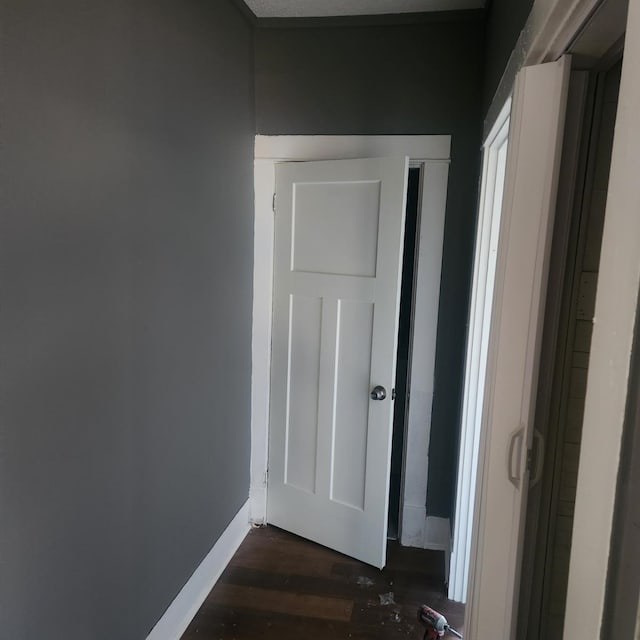 hallway with dark hardwood / wood-style flooring