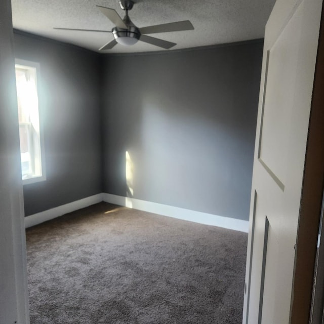 unfurnished room featuring carpet, a textured ceiling, and ceiling fan