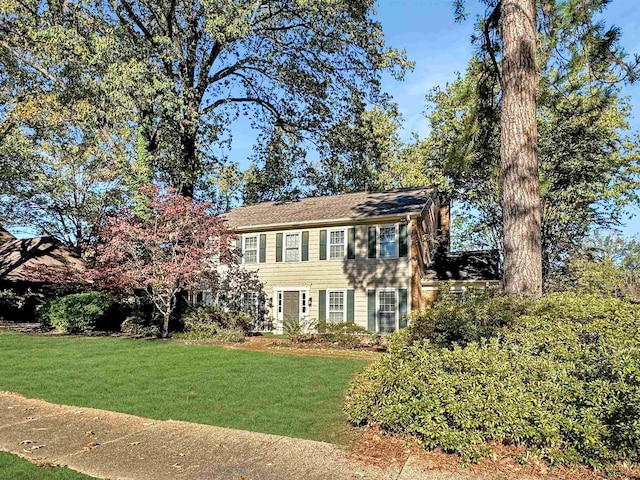 colonial home with a front lawn