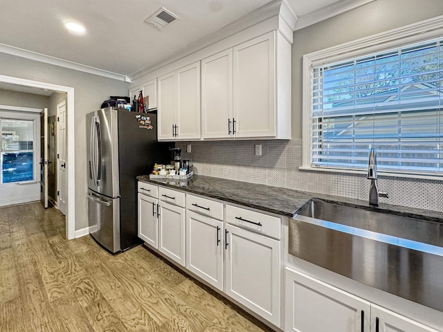 kitchen with white cabinetry and ornamental molding