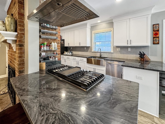 kitchen featuring dishwasher, backsplash, premium range hood, white cabinets, and sink