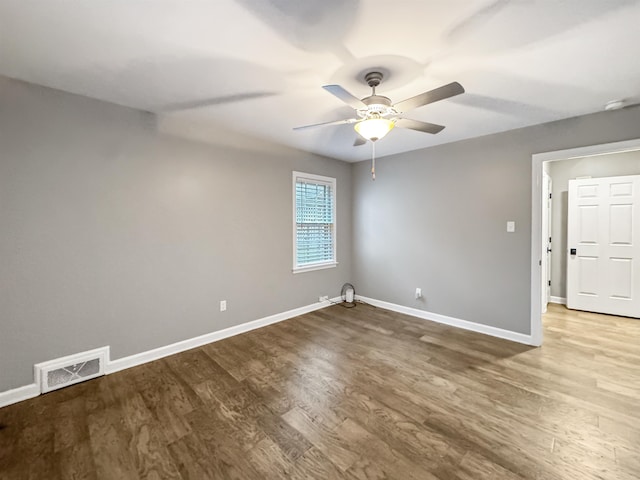 spare room with wood-type flooring and ceiling fan