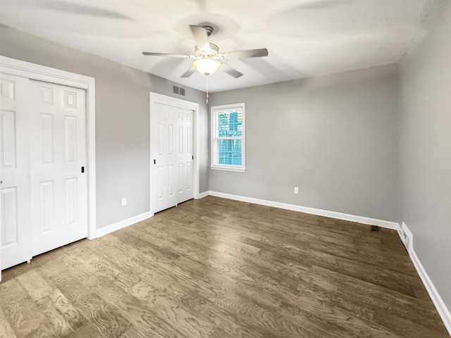 unfurnished bedroom with ceiling fan and hardwood / wood-style floors