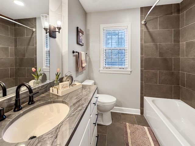 full bathroom with tile patterned flooring, vanity, tiled shower / bath combo, and toilet