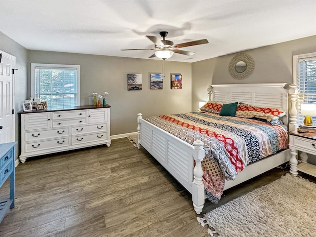 bedroom with dark hardwood / wood-style flooring and ceiling fan