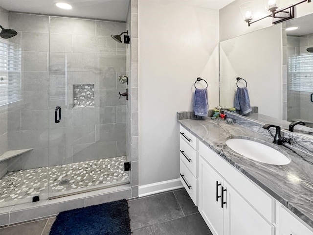 bathroom with tile patterned flooring, vanity, an enclosed shower, and a chandelier