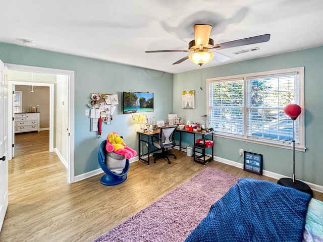 bedroom with light hardwood / wood-style flooring and ceiling fan