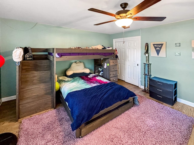 bedroom with a closet, ceiling fan, and hardwood / wood-style floors