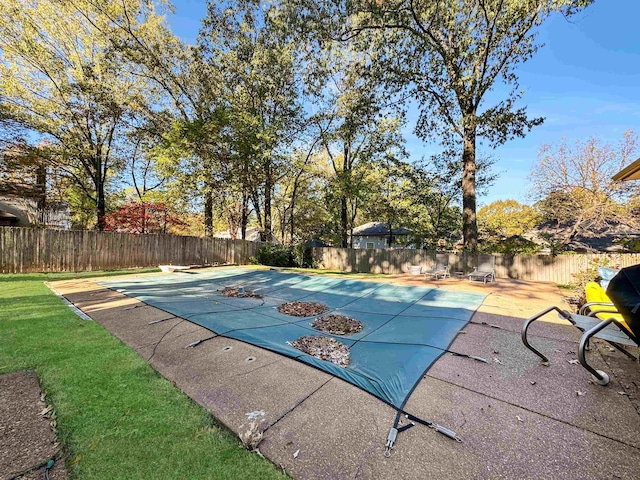 view of swimming pool featuring a diving board and a patio