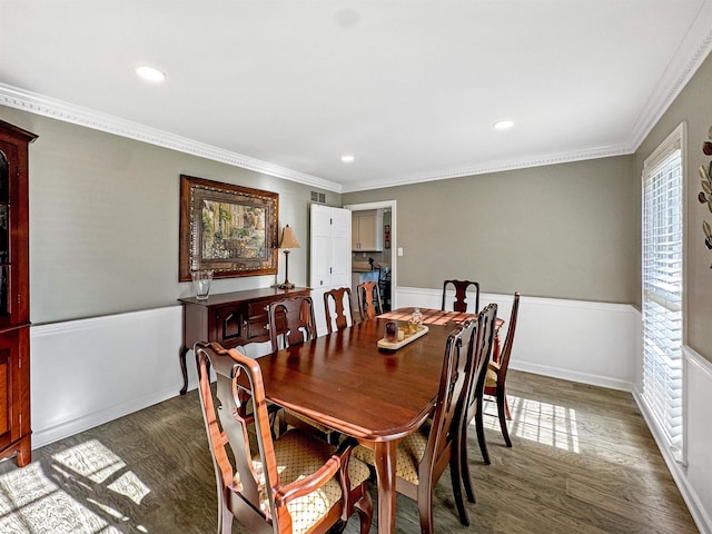 dining space featuring crown molding and dark hardwood / wood-style floors