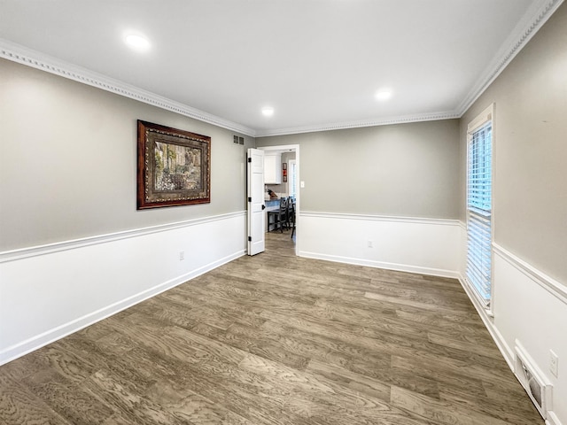 unfurnished room featuring hardwood / wood-style floors and crown molding