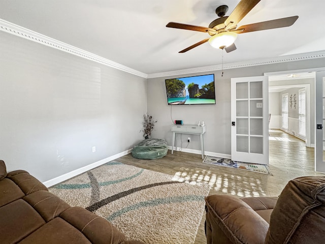 living room with hardwood / wood-style floors, french doors, ornamental molding, and ceiling fan