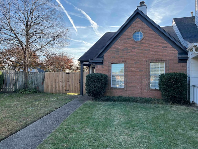 view of side of property with a lawn