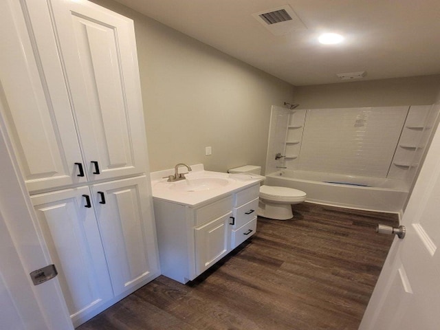 full bathroom with shower / bathing tub combination, wood-type flooring, vanity, and toilet