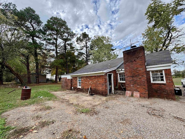 view of side of home with a lawn