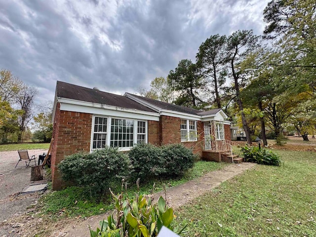 view of side of property with a yard