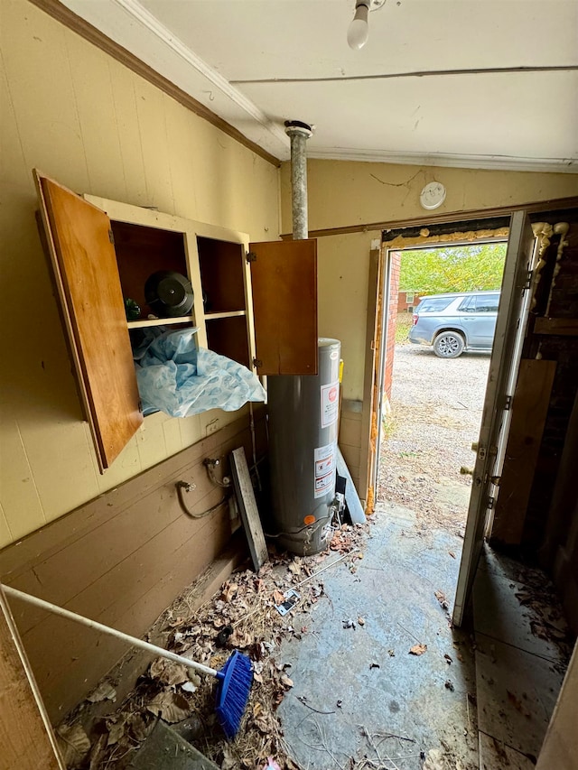 misc room featuring lofted ceiling and gas water heater