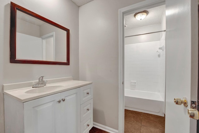 bathroom featuring tile patterned floors, vanity, washtub / shower combination, and a textured ceiling