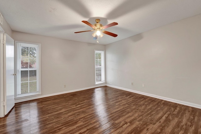 unfurnished room with a textured ceiling, ceiling fan, and dark wood-type flooring