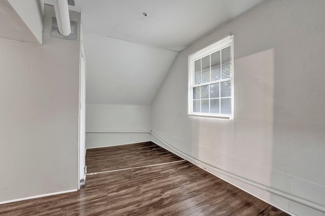 additional living space with dark hardwood / wood-style floors and lofted ceiling