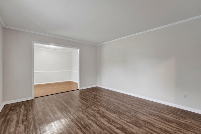 empty room featuring hardwood / wood-style flooring and ornamental molding