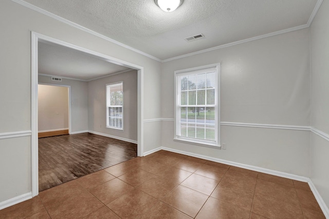 empty room with a textured ceiling, dark hardwood / wood-style floors, and ornamental molding