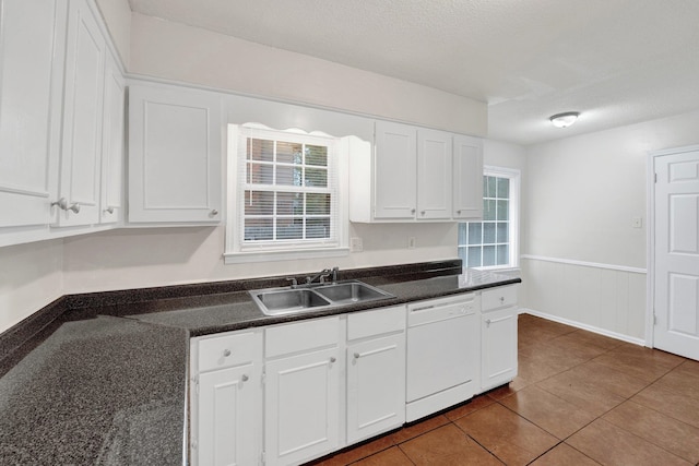 kitchen featuring dishwasher, white cabinets, and sink